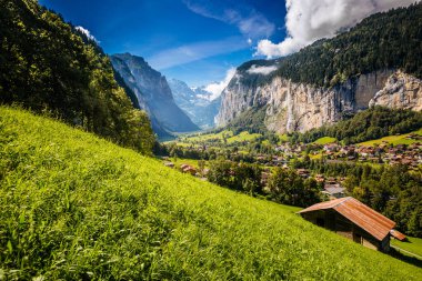 Güneş ışığıyla parlayan harika bir dağ köyü manzarası. Resimli ve muhteşem bir sahne. Popüler turist eğlencesi. İsviçre Alpleri, Lauterbrunnen Vadisi Staubbach Şelalesi, Avrupa. Güzellik dünyası