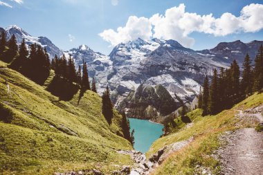 Buzul göleti Oeschinensee. Popüler turist eğlencesi. Resimli ve muhteşem bir sahne. İsviçre Alpleri, Kandersteg, Bernese Oberland, Avrupa. Bağbozumu etkisi. Instagram filtrelenmiş. Güzellik dünyası.