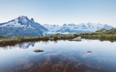 Mont Blanc buzulu ve Lac Blanc manzarası. Mükemmel ve muhteşem bir sahne. Doğa koruma alanı Aiguilles Rouges, Graian Alpleri, Fransa, Avrupa. Bağbozumu etkisi. Instagram filtresi. Güzellik dünyası.
