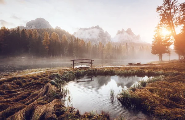 Great view of the foggy lake Antorno in National Park Tre Cime di Lavaredo. Location Auronzo, Misurina, Dolomiti alps, South Tyrol, Italy, Europe. Vintage style. Instagram toning effect. Beauty world.