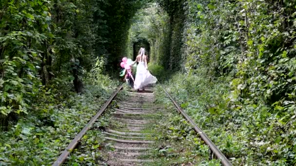 Счастливая Невеста Идущая Рельсам Посреди Летнего Леса — стоковое видео