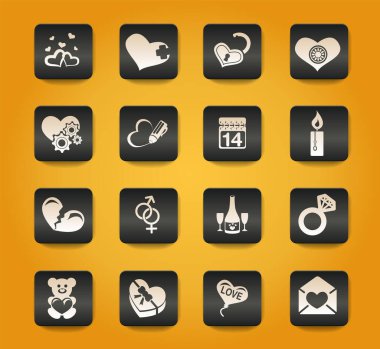 Sarı zemin üzerindeki siyah düğmelerde sevgililer günü ve aşk sembolleri