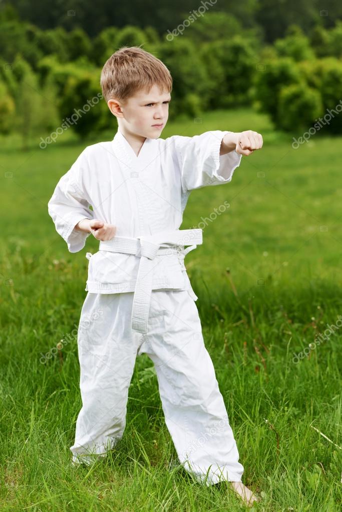 Little boy make karate exercises