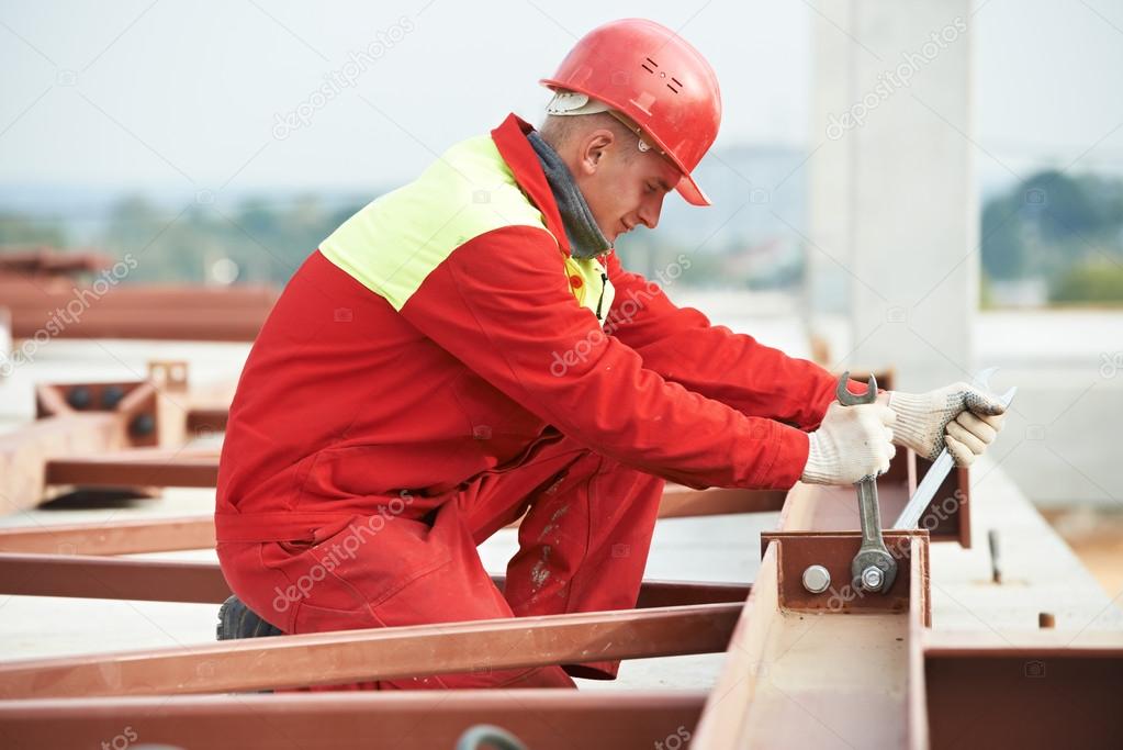 Builder worker assembling metal construction