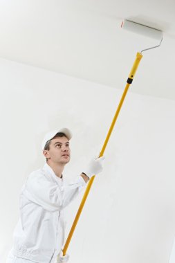House painter at work with painting roller clipart