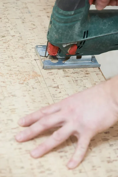 Cutting cork board with jigsaw — Stock Photo, Image