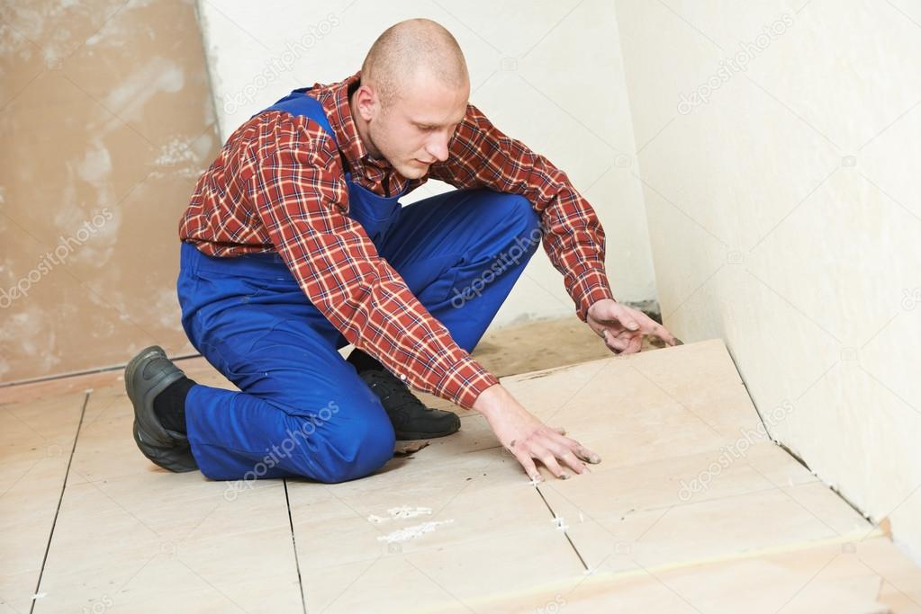 Tiler at home floor tiling renovation work — Stock Photo © kalinovsky