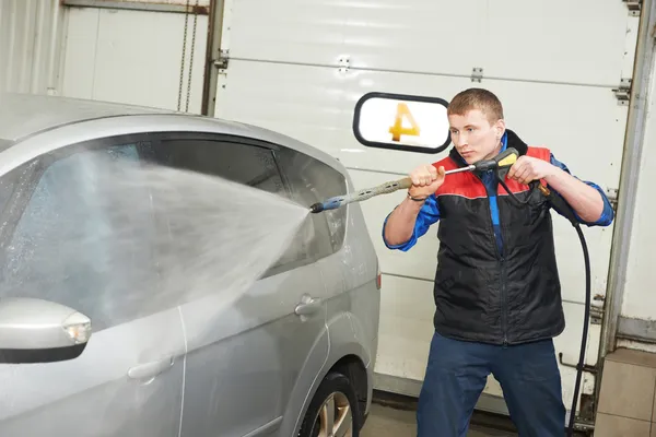 Arbeiter reinigt Auto mit Druckwasser — Stockfoto