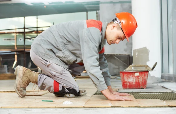 Tiler at industrial floor tiling renovation work — Stock Photo, Image
