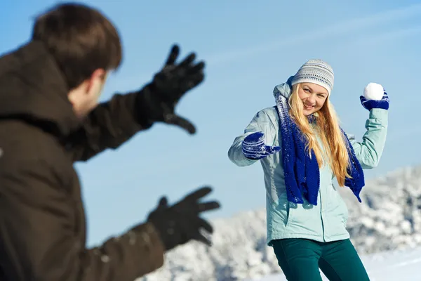 Young peolple playing snowballs in winter Stock Image