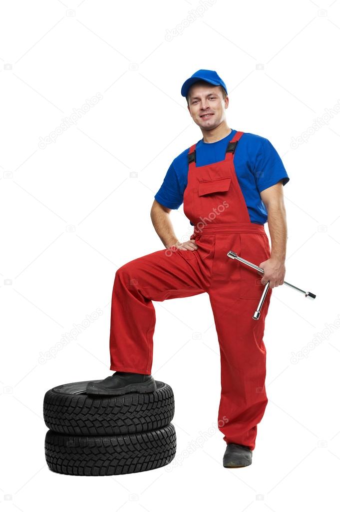 Automobile mechanic with car tire and spanner