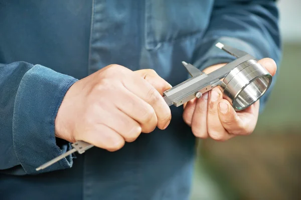 Worker measuring detail with caliper — Stock Photo, Image