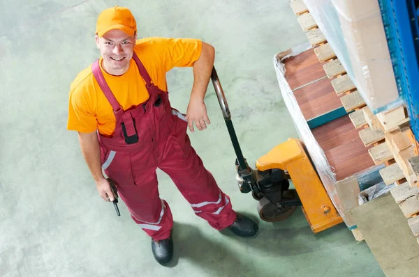 Waregouse worker with fork pallet truck — Stock Photo, Image