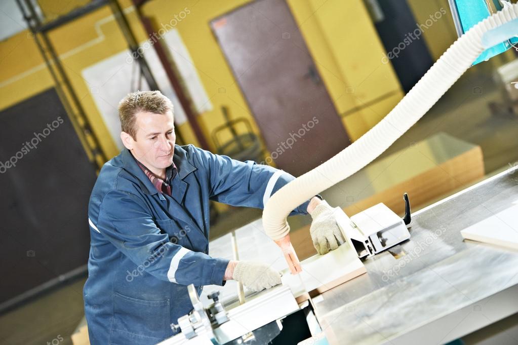 Worker at workshop with circ saw