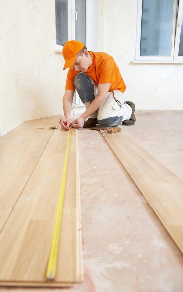 Carpenter worker joining parket floor