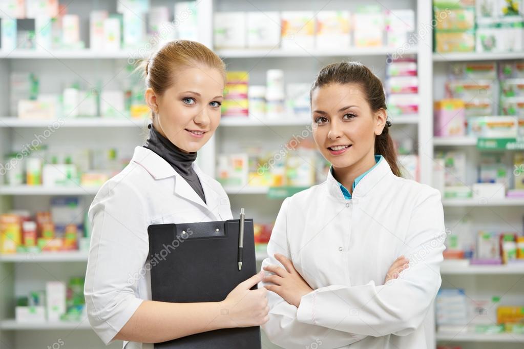 Two Pharmacy chemist women in drugstore