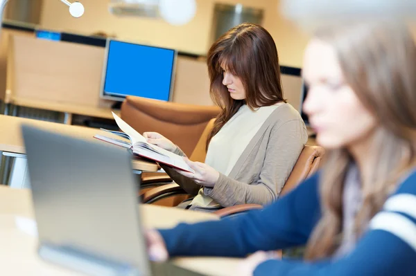 Female student girl with book in library — Stock Photo, Image