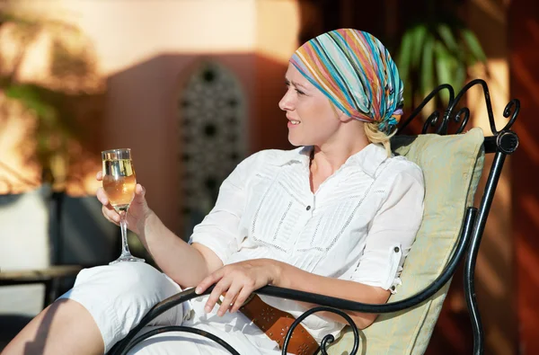 Woman with glass of wine at vacation resort — Stock Photo, Image