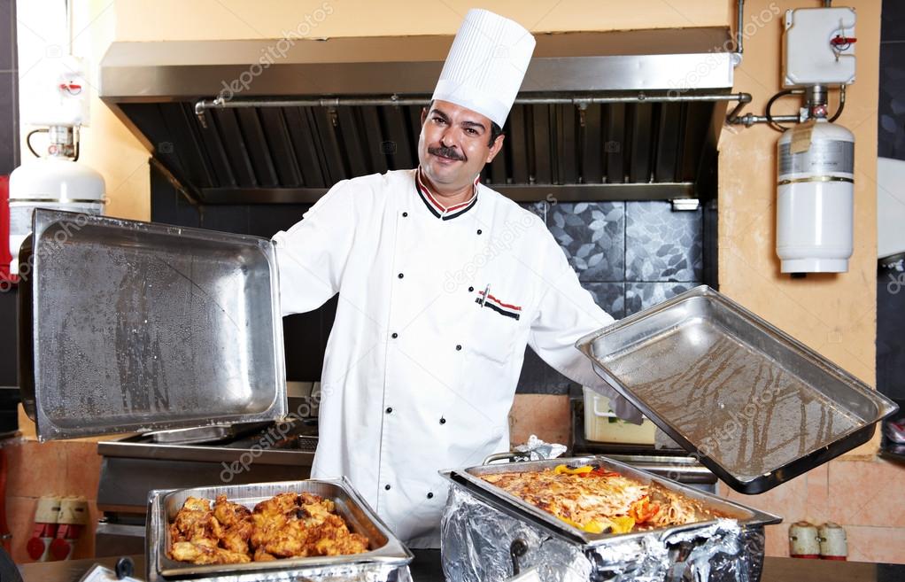 Arab chef with food at restaurant hotel