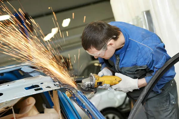Repairman grinding metal body car — Stock Photo, Image
