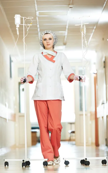 Young medic nurse with droppers in hospital — Stock Photo, Image