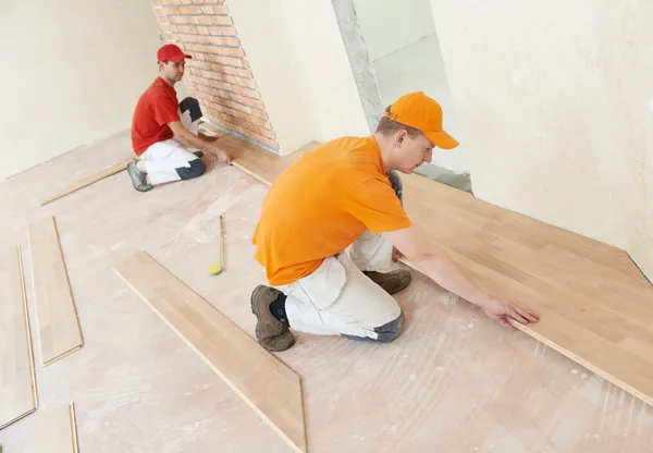 Parquet workers at flooring work — Stock Photo, Image