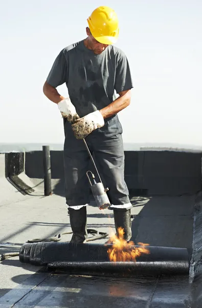 Flat roof covering repair works with roofing felt — Stock Photo, Image