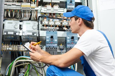 Electrician worker inspecting clipart