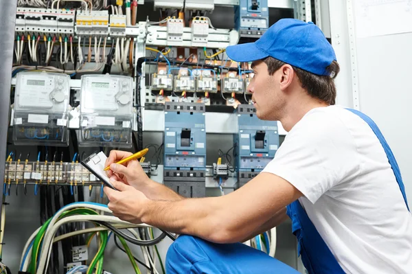 Electrician worker inspecting Stock Picture