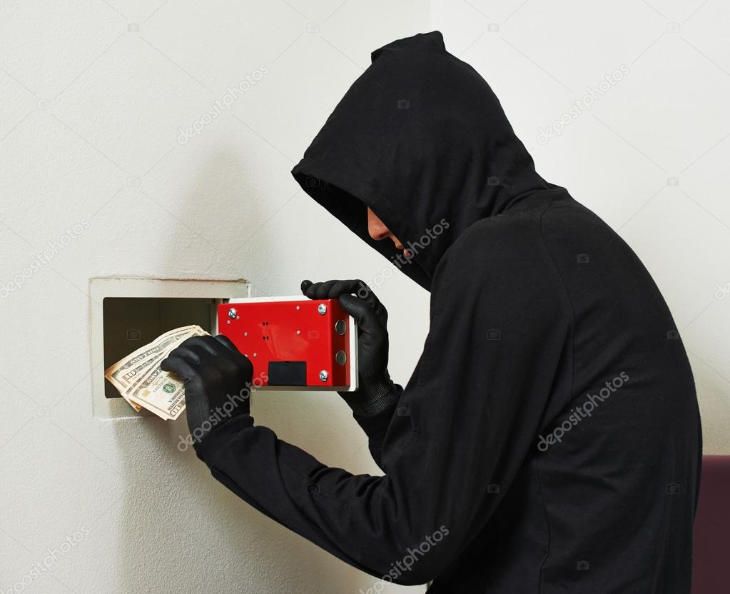 Thief burglar at house safe breaking