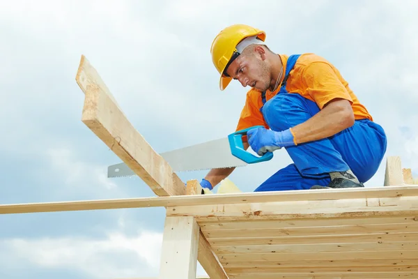 Carpenter works with hand saw — Stock Photo, Image