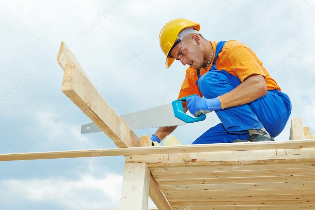 Carpenter works with hand saw