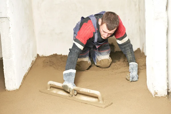 Plasterer concrete worker at floor work — Stock Photo, Image