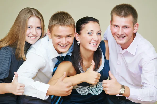 Young smiling peoples thumb up — Stock Photo, Image