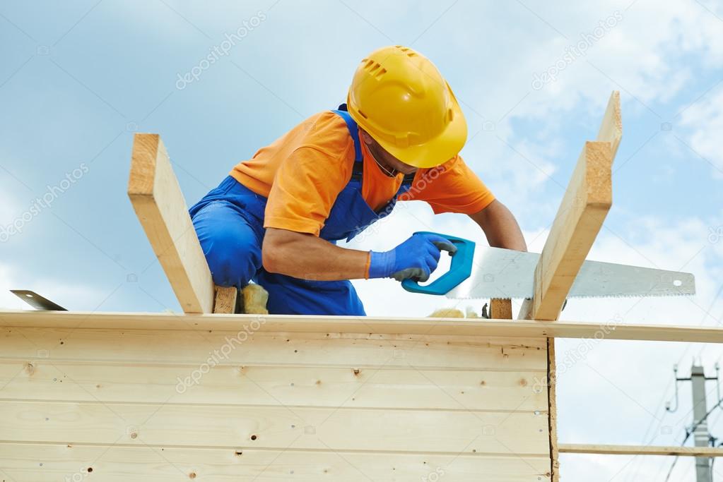 Carpenter works with hand saw