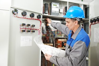 Electrician working at power line box clipart
