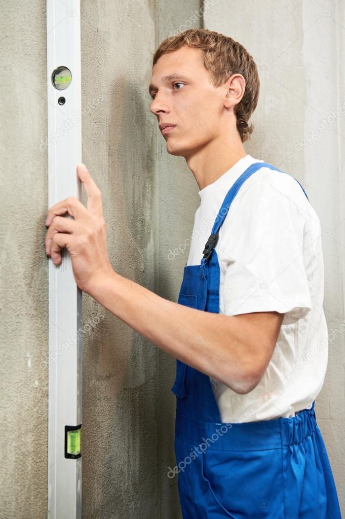 Young carpenter man worker with level