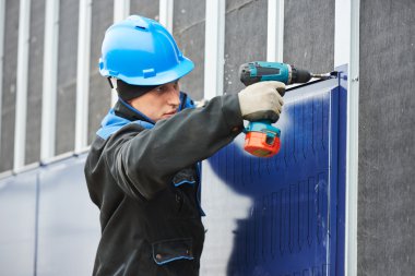 Worker assembling facade metal construction clipart