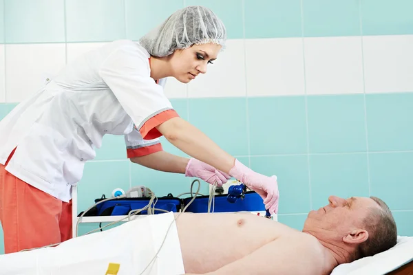 Medic nurse with patient at electrocardiogram — Stock Photo, Image