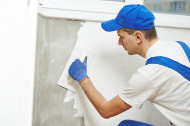 Plasterer at indoor wall work clipart