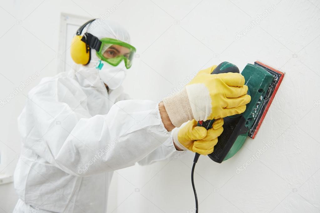 Worker with sander at wall filling Stock Photo by ©kalinovsky 35855037