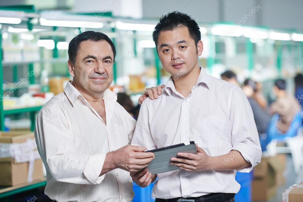 Manager and chinese worker in factory