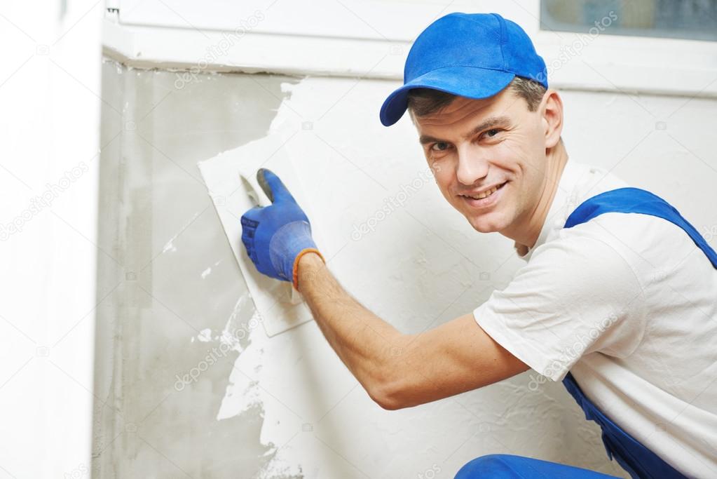 Plasterer at indoor wall work — Stock Photo © kalinovsky 36599871