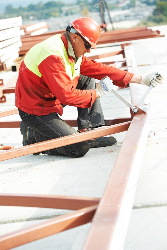 Builder worker assembling metal construction