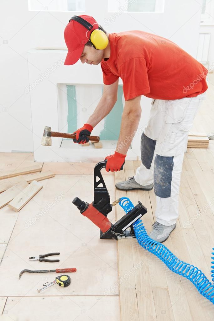 Carpenter worker joining parket floor
