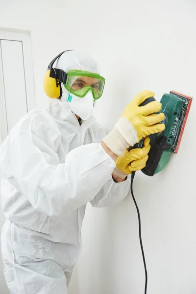 Worker with sander at wall filling — Stock Photo, Image