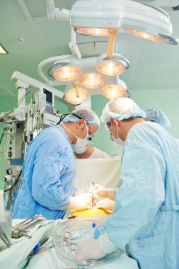 Surgeons team at cardiac surgery operation clipart