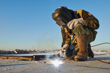 Welder at construction site clipart