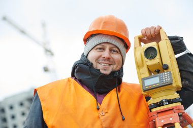 Portrait of surveyor worker with theodolite clipart