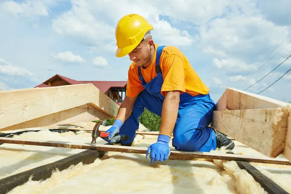 Roofer carpenter works on roof — Stock Image Roofer carpenter works on roof Royalty Free Stock Images